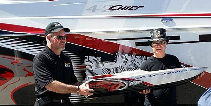Eric Dorris (left) and Dean Loucks pose for photos next to the full-size 42 Warrior from Chief Powerboats. Photo courtesy Chief Powerboats