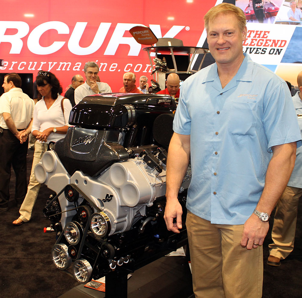 Mercury Racing's Erik Christiansen stands next to the 1650 Race engine at its Miami Boat Show debut.