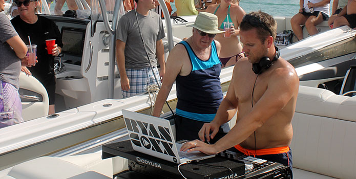 DJ Ryan Coxx set up shop on a Nor-Tech 420 Monte Carlo to entertain the raft-up at Boca Grande Key on Saturday. (Click on image for full picture.)