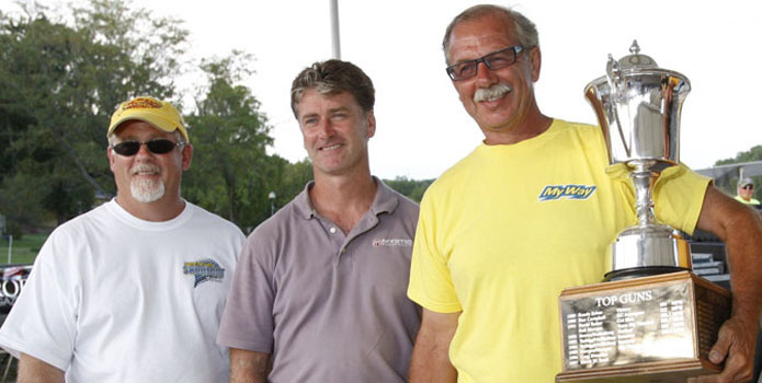 Duggan presents the 2011 Top Gun trophy to Bill Tomlinson (holding trophy), joined by throttleman Ken Kehoe (right) and Mystic Powerboats owner John Cosker. (Photos courtesy of Ron Duggan & Robert Brown.)