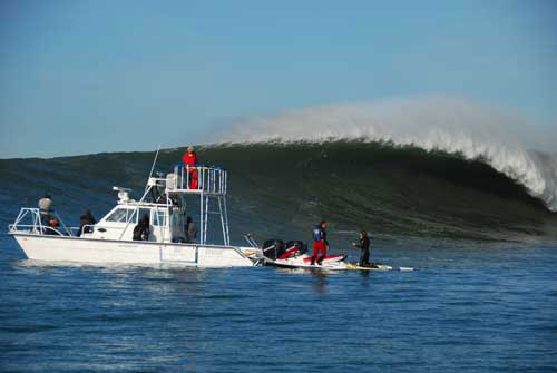 Photographers such as Robert, shown here in his boat at Mavericks, relied on Sean Collins for is remarkably accurate big-wave forecasts.