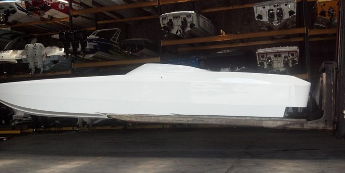 Looking ghostly in pre-graphics form, Hayim's 48' MTI is being rigged with Mercury Racing 1350s at TNT Custom Marine.