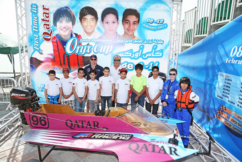 Junior hydro racers line up with Sheikh Hassan bin Jabor Al-Thani and J.W. Myers. Photo by Bill Osborne 