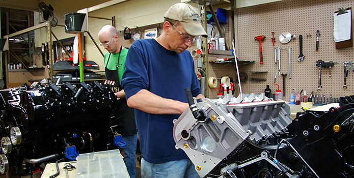 Mercury Racing's Doug Peterson (front) and Mike Critchley work on refreshing quad-cam, four-valve 1100 and 1350 engines. Photo courtesy Mercury Racing